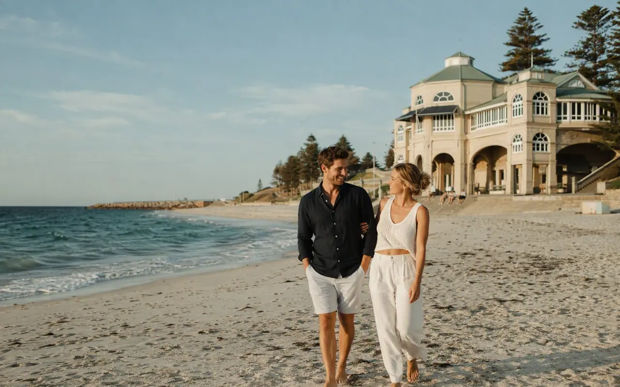 Couple walking along Cottesloe Beach, Perth